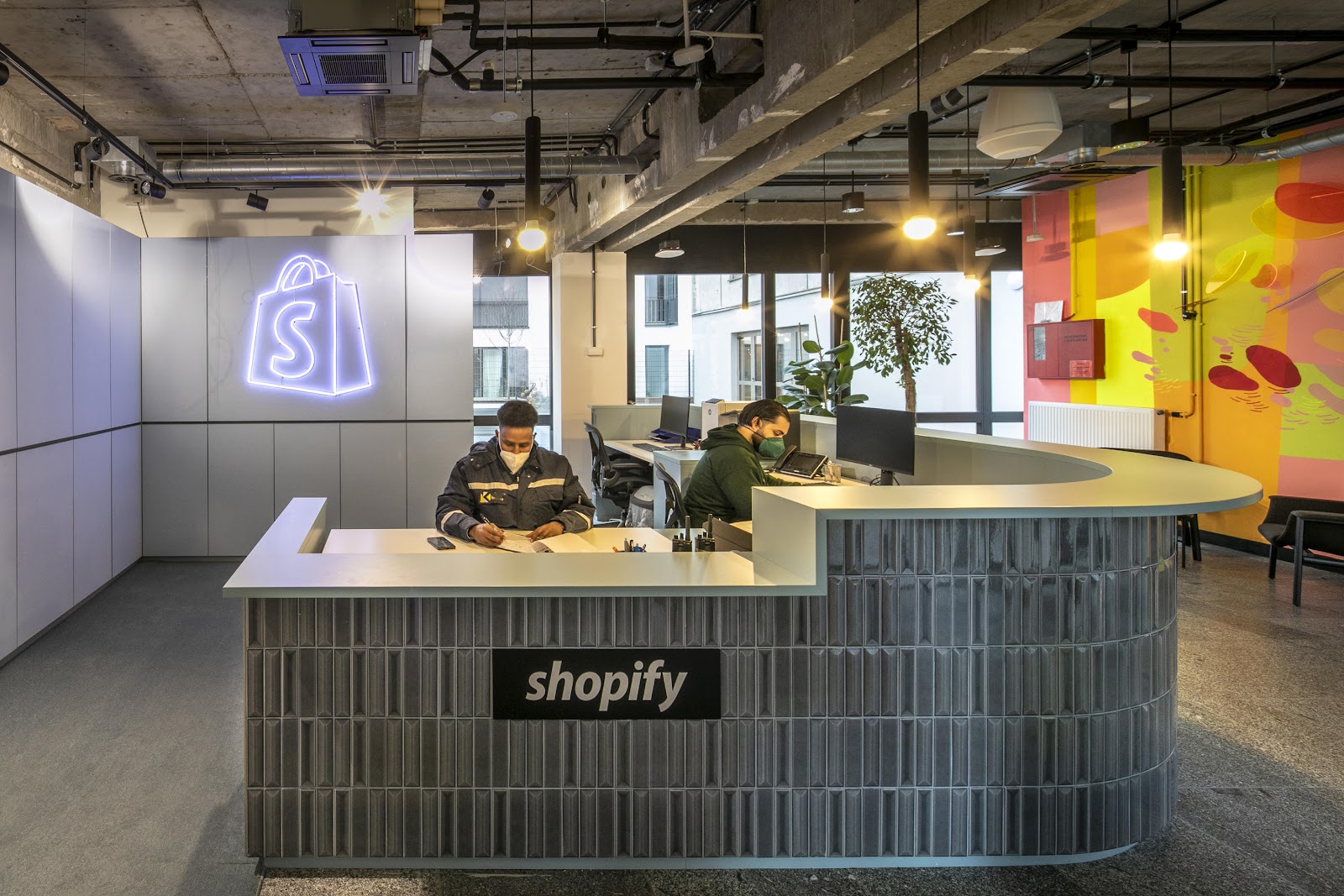 Shopify employees working at a welcome desk